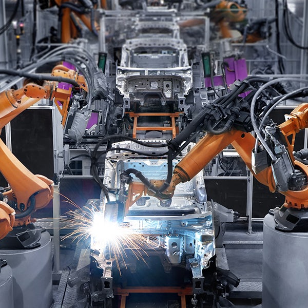 A robot is welding a car in a factory.