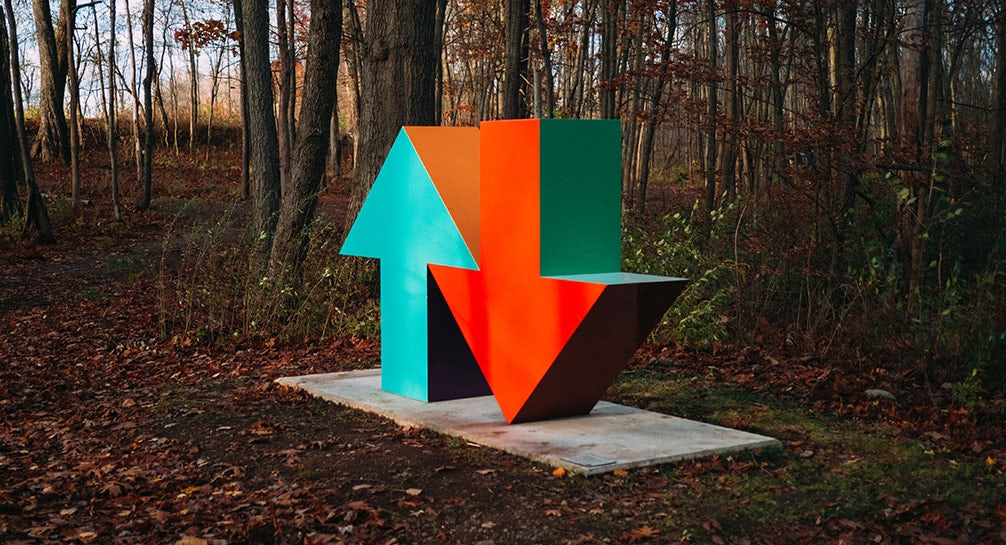 A colorful sculpture in the woods.
