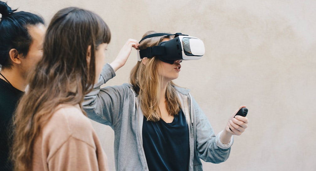 A group of women are looking at a vr headset.
