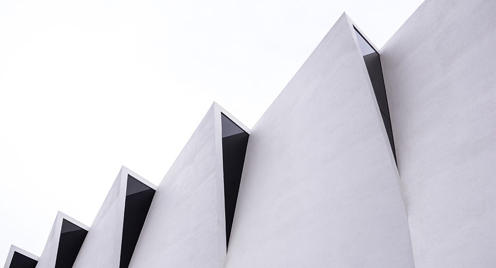 A close up of a white building with a zig zag pattern.