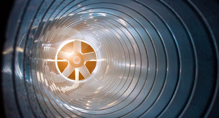 A close up of a metal tube with a light in it.