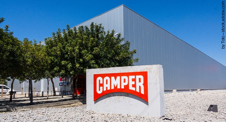 A sign for camper in front of a building.