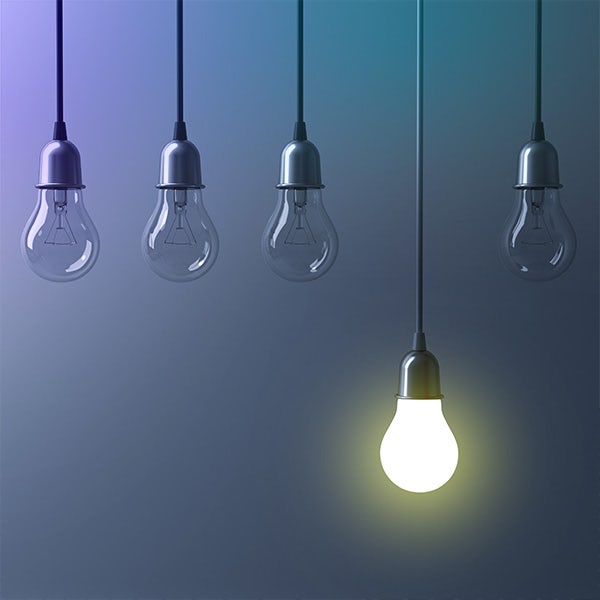 A group of light bulbs hanging from a string on a blue background.