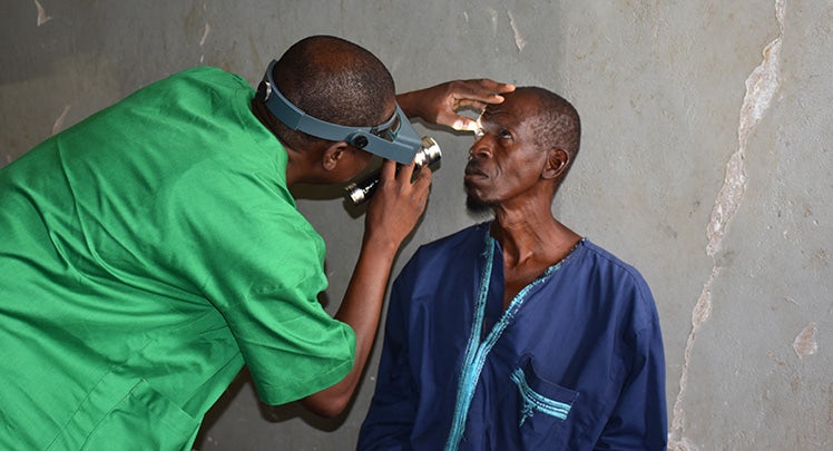 A man is having his eyes examined by a doctor.