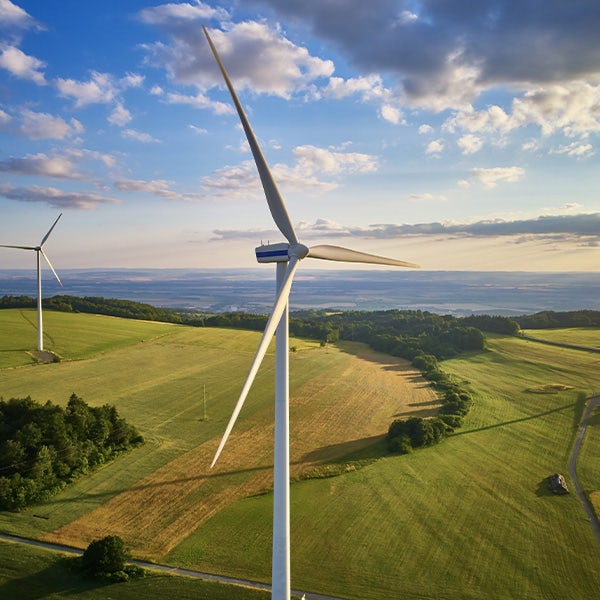 An aerial view of wind turbines in a field.