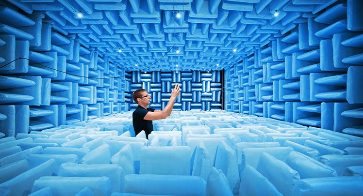 A man standing in an acoustic room.