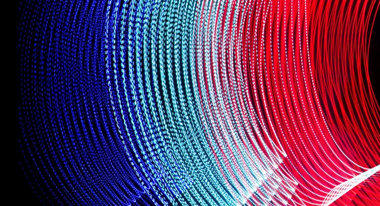 A red, blue, and white light wave on a black background.