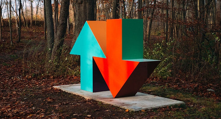 A sculpture in a wooded area.