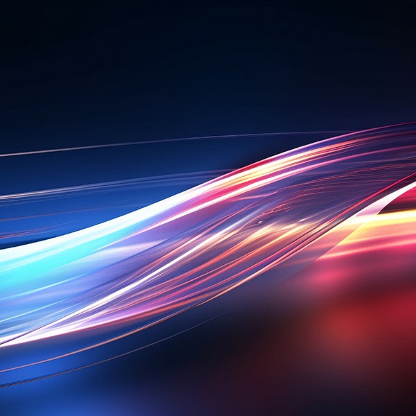 An abstract image of light streaks on a dark background.