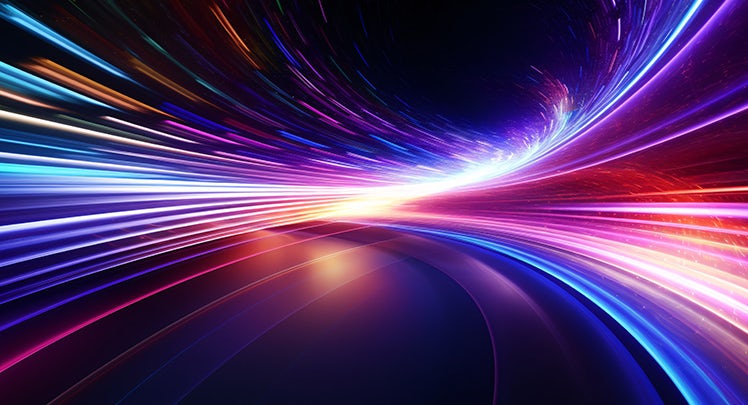 An abstract image of a colorful light streak on a dark background.