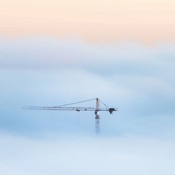 Construction crane in the fog.