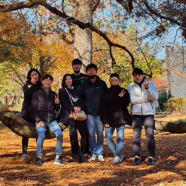 A group of people posing for a photo in a park.