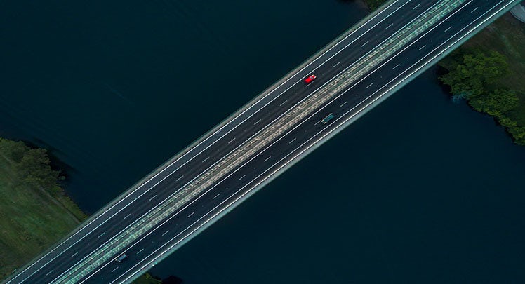 An aerial view of a bridge over a body of water.