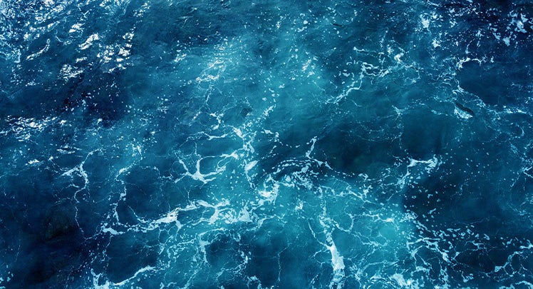 An aerial view of the ocean with blue water.