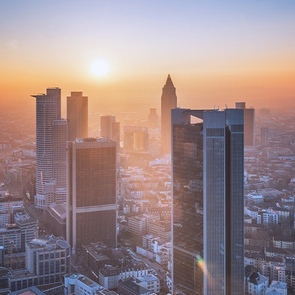 An aerial view of the city of frankfurt at sunset.