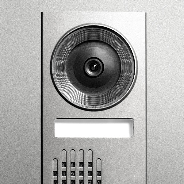 A metal doorbell with a camera on it.