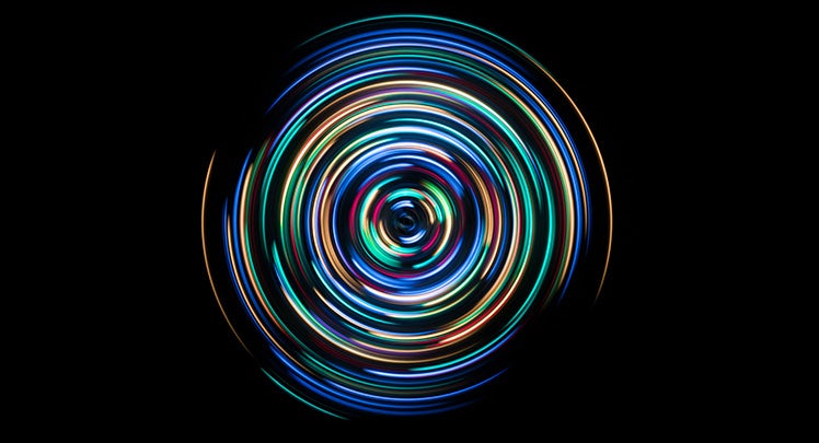 A colorful light spiral on a black background.
