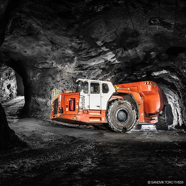 A red and white truck in a tunnel.