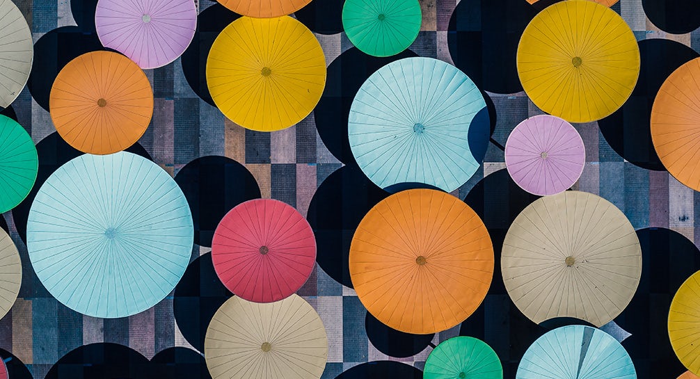 A group of colorful umbrellas on a wall.
