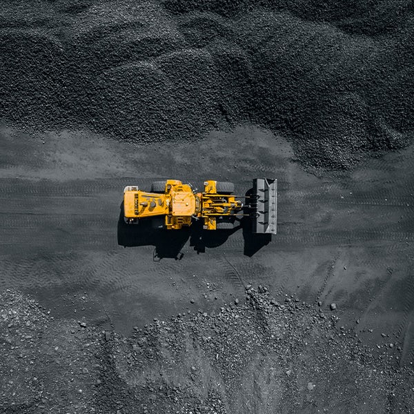 An aerial view of a bulldozer in a coal mine.