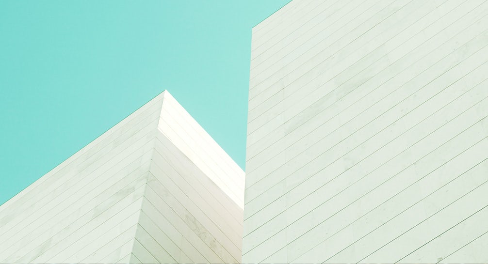 A white building against a blue sky.