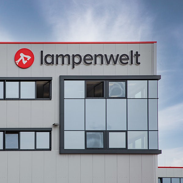 Building with windows and a Lampenwelt logo sign