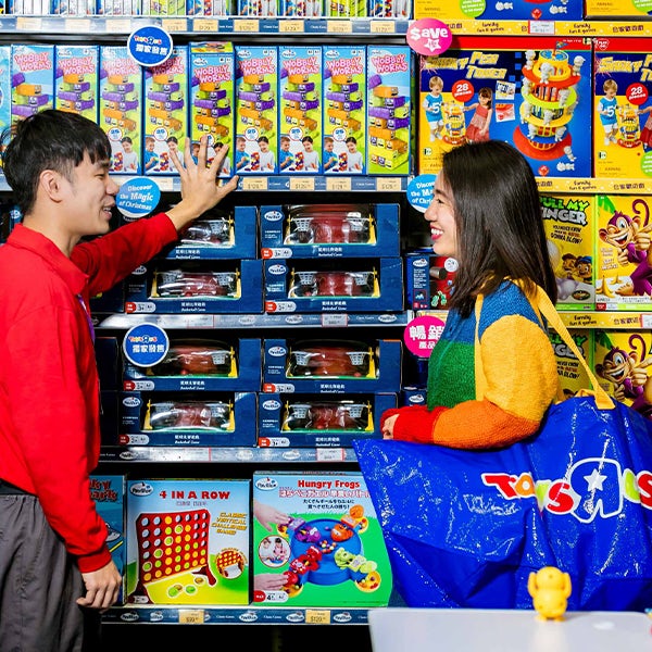 A man and a woman in a toy store.