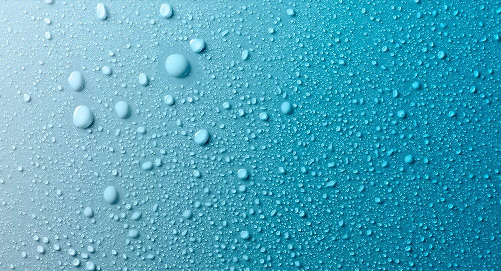 Water droplets on a blue background.