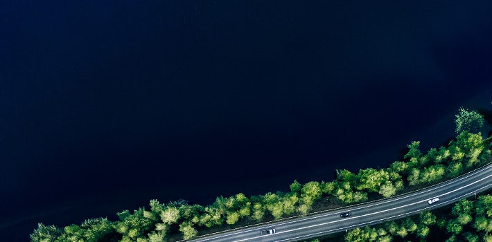 An aerial view of a road near a body of water.