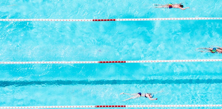 An aerial view of people swimming in a pool.
