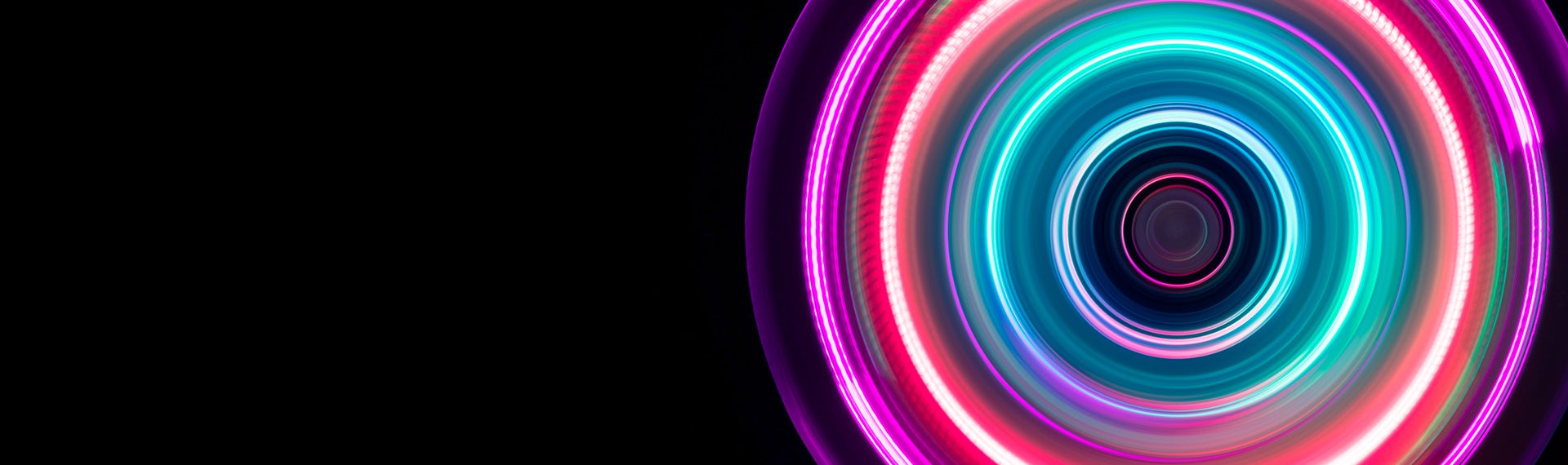A colorful neon ring on a black background.