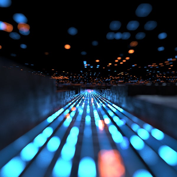 A blurry image of a dark tunnel with blue lights.