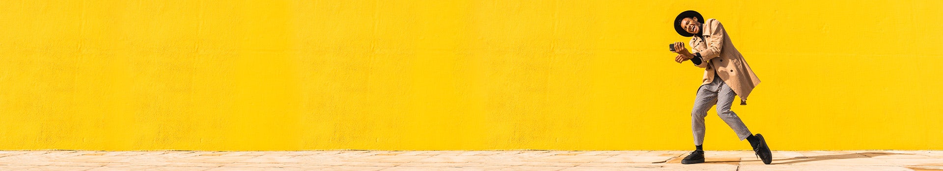 young-man-dancing-in-front-of-yellow-wall-getty-1292965830-hero