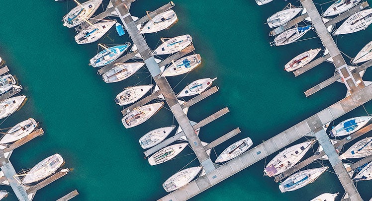 An aerial view of boats docked in a marina.