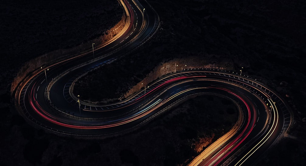 Aerial view of a winding road at night.