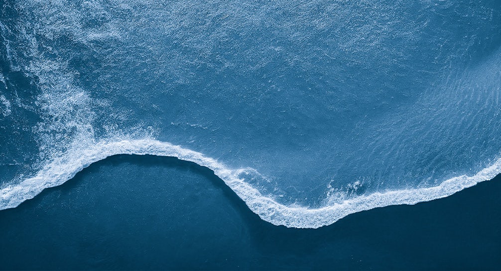 An aerial view of a wave in the ocean.